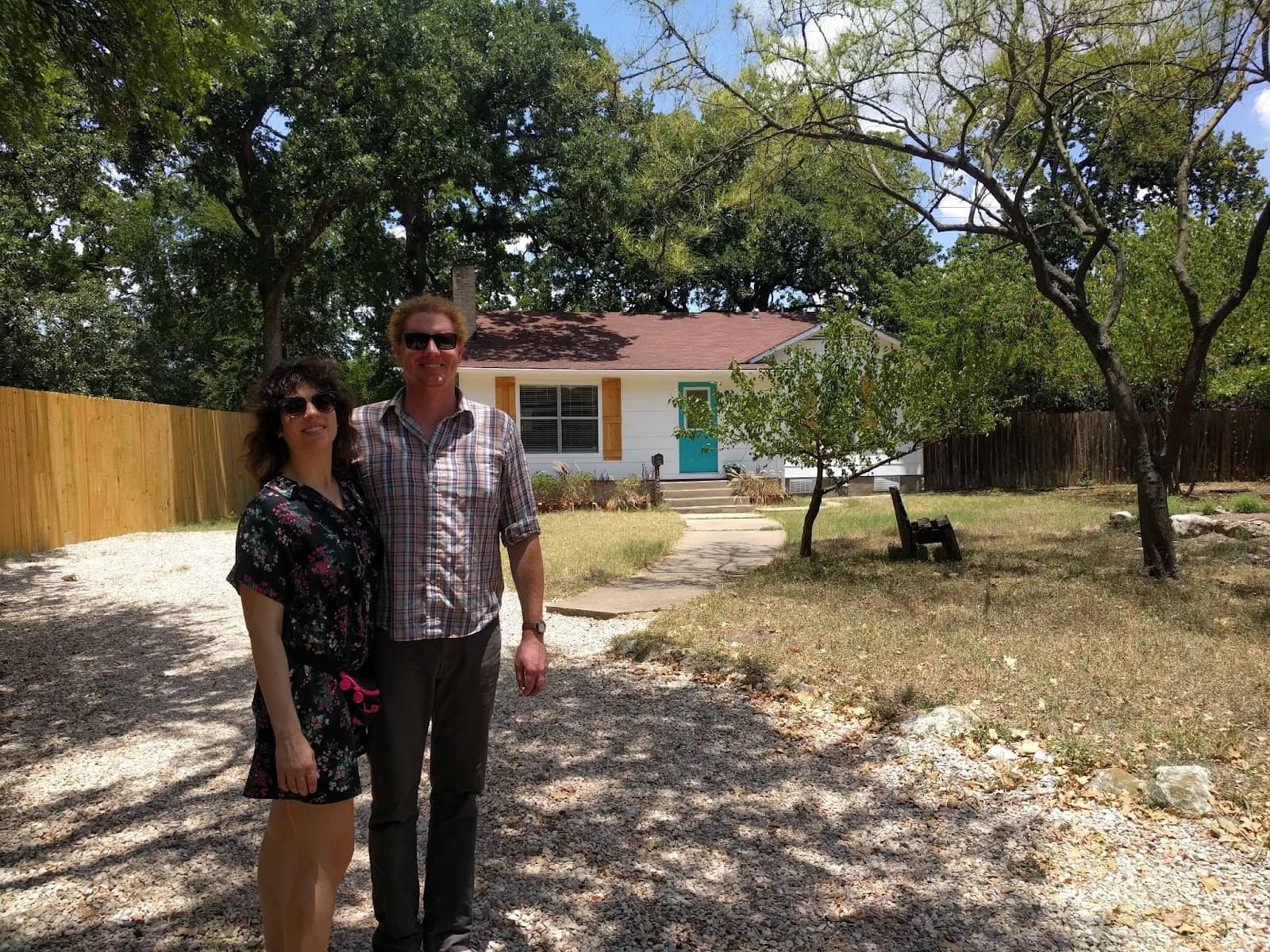 michael and his partner stand proudly in front of their new home